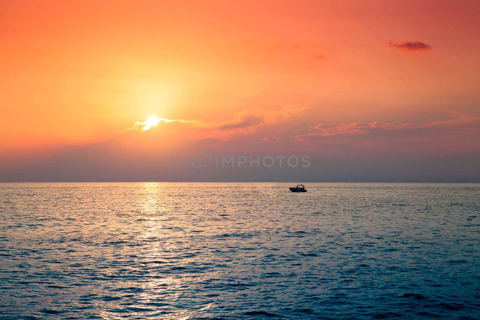 Lone boat in the sea at the beautiful sunset