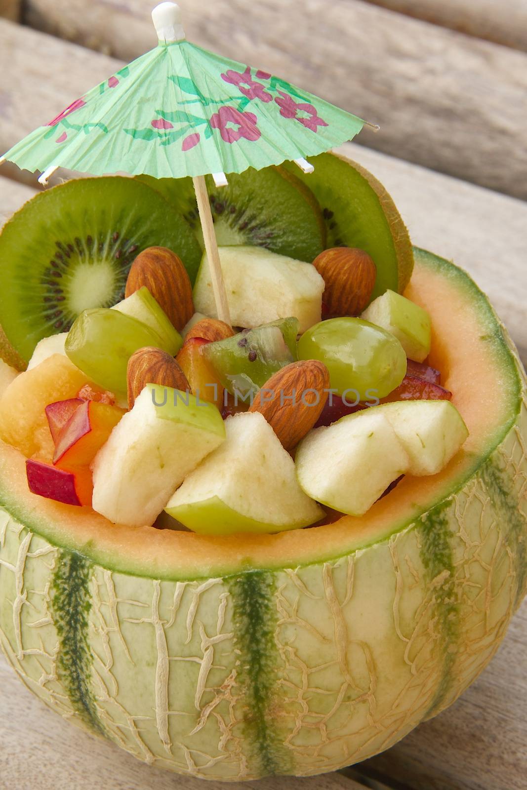 Vitamin dessert- fruit salad in the honeydew melon skin. Close up