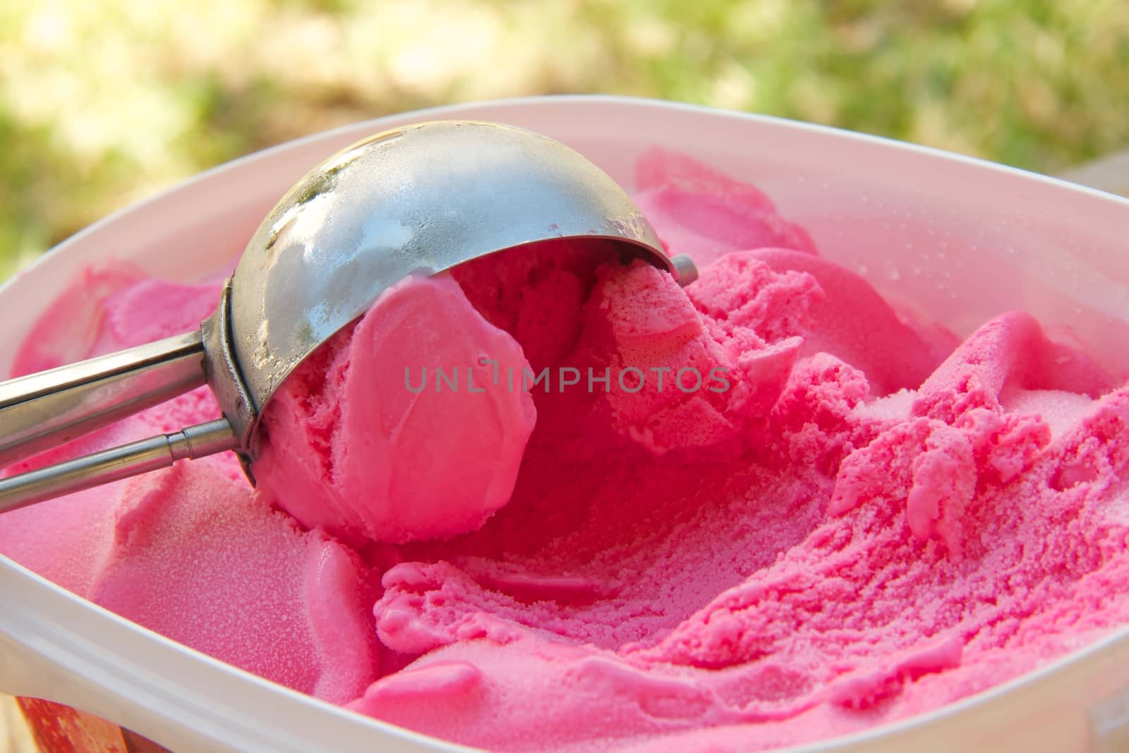 Red berries ice-cream and an ice-cream spoon