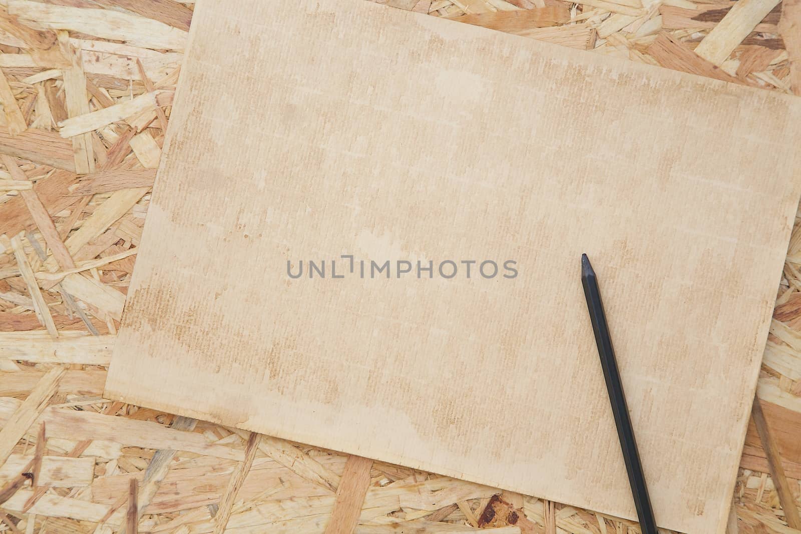 A sheet of old carton paper and a pencil by tolikoff_photography