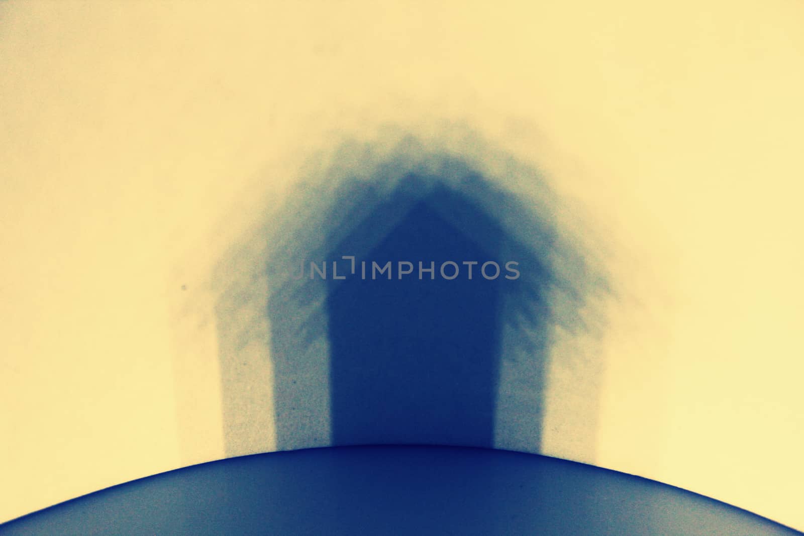 Multiple shadow of Miniature Home on wall