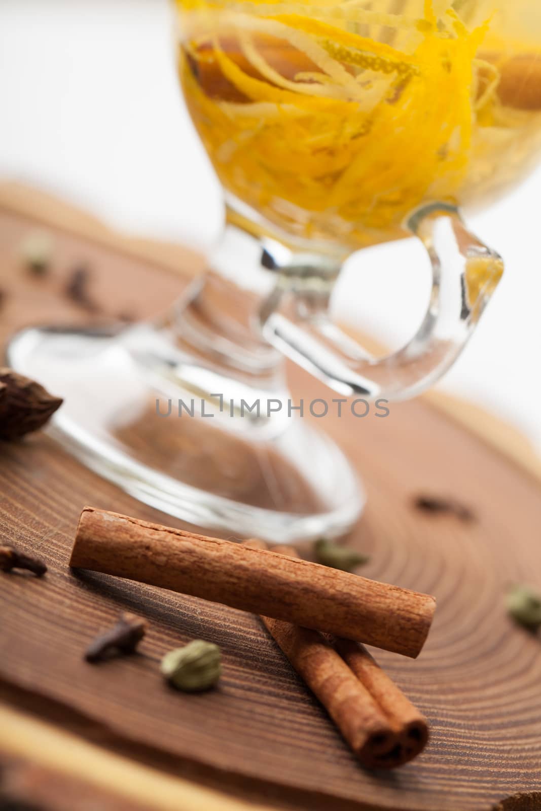 Traditional winter sweet hot alcohol drinks mulled white rum with orange, spices, cinnamon, rosemary, anise served on wooden board