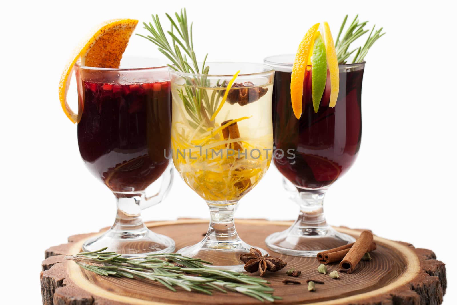 Variety of traditional winter sweet hot alcohol drinks mulled red wine  glintwine and  white rum with orange, spices, cinnamon, rosemary, anise served on wooden board