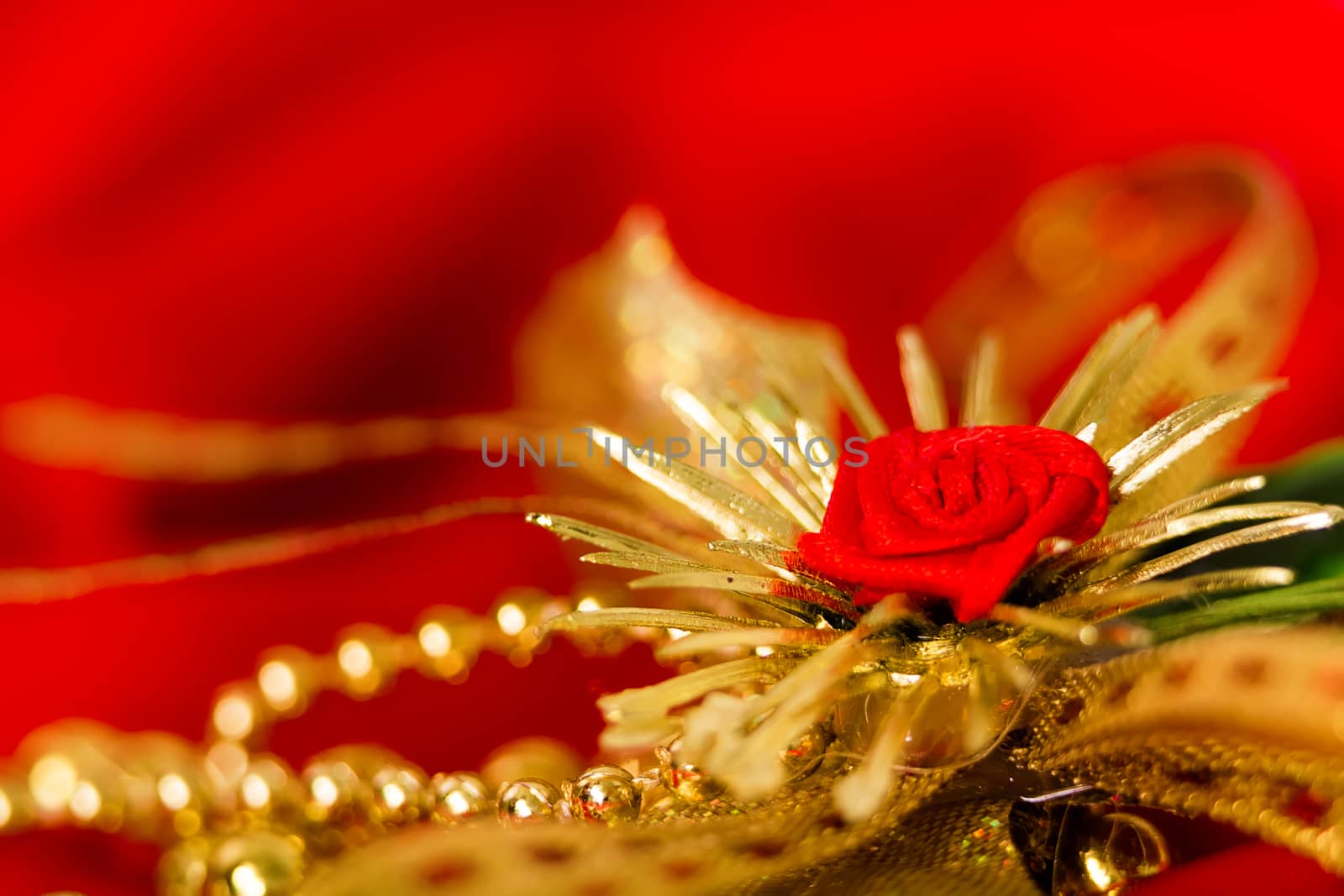 Christmas golden decoration on red fabric. macro