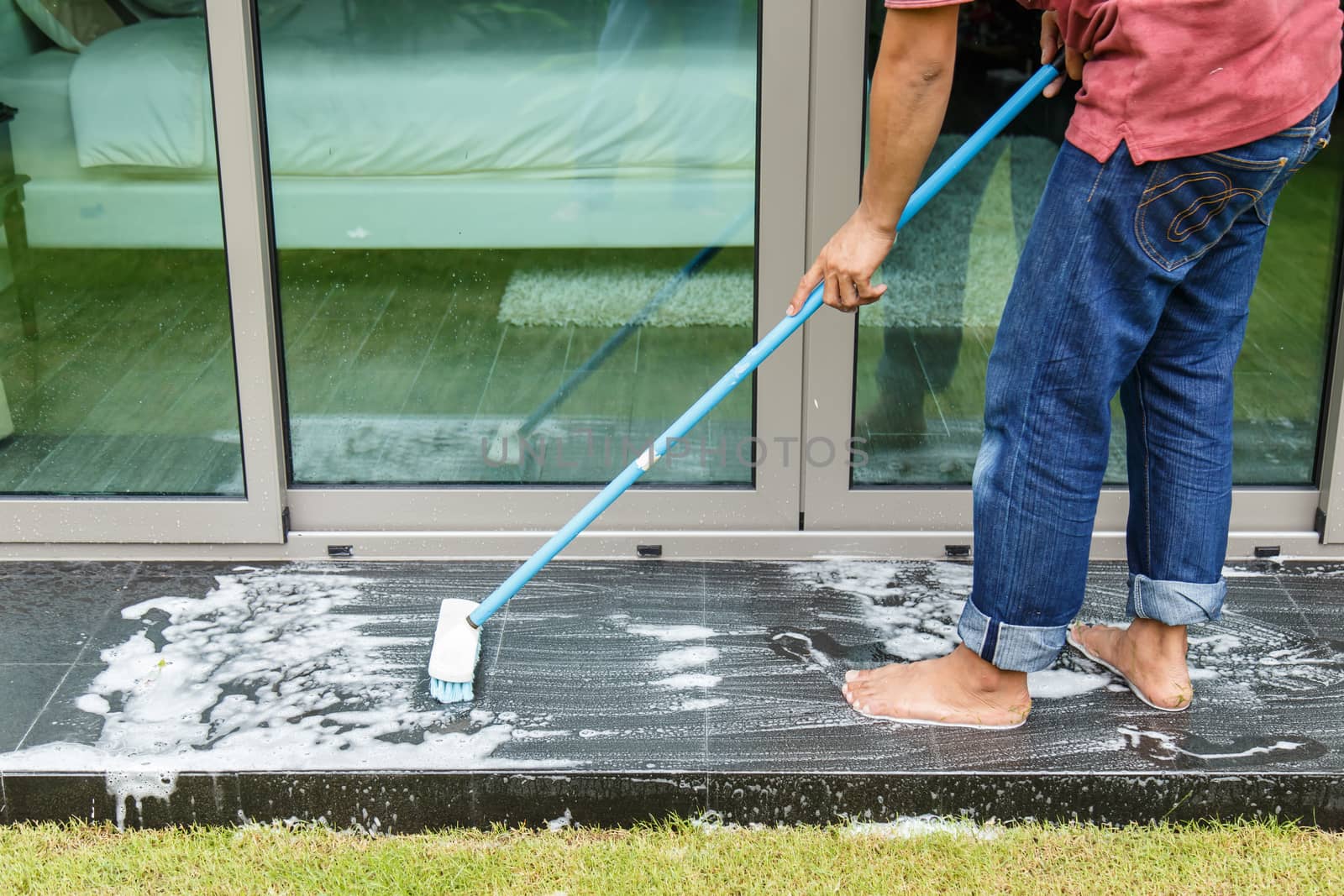 Thai people cleaning black granite floor with brush and chemical