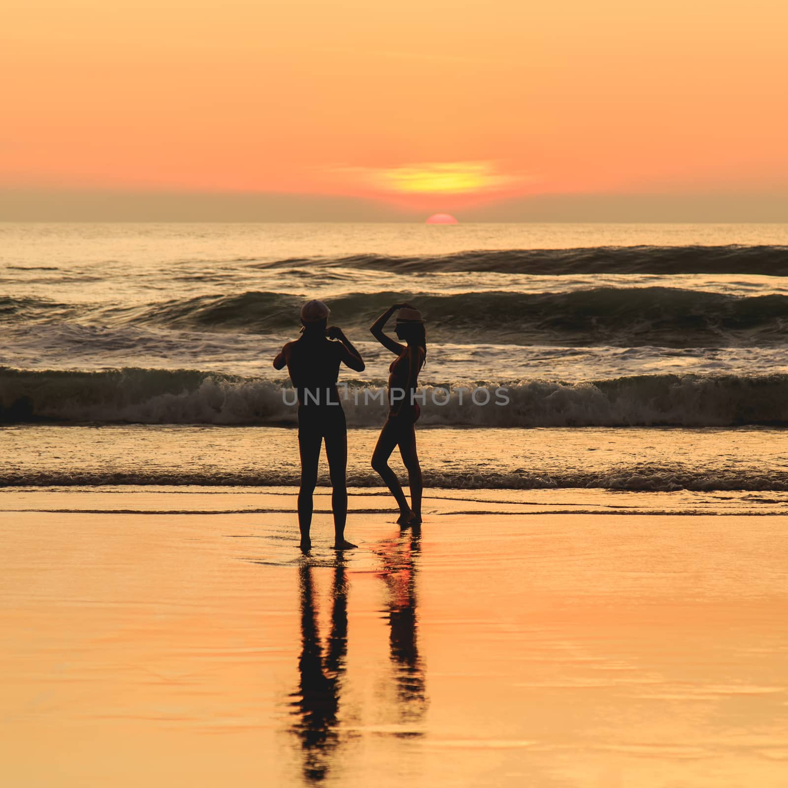 Silhouette of tourist at sunset beach in Phuket Thailand by nanDphanuwat