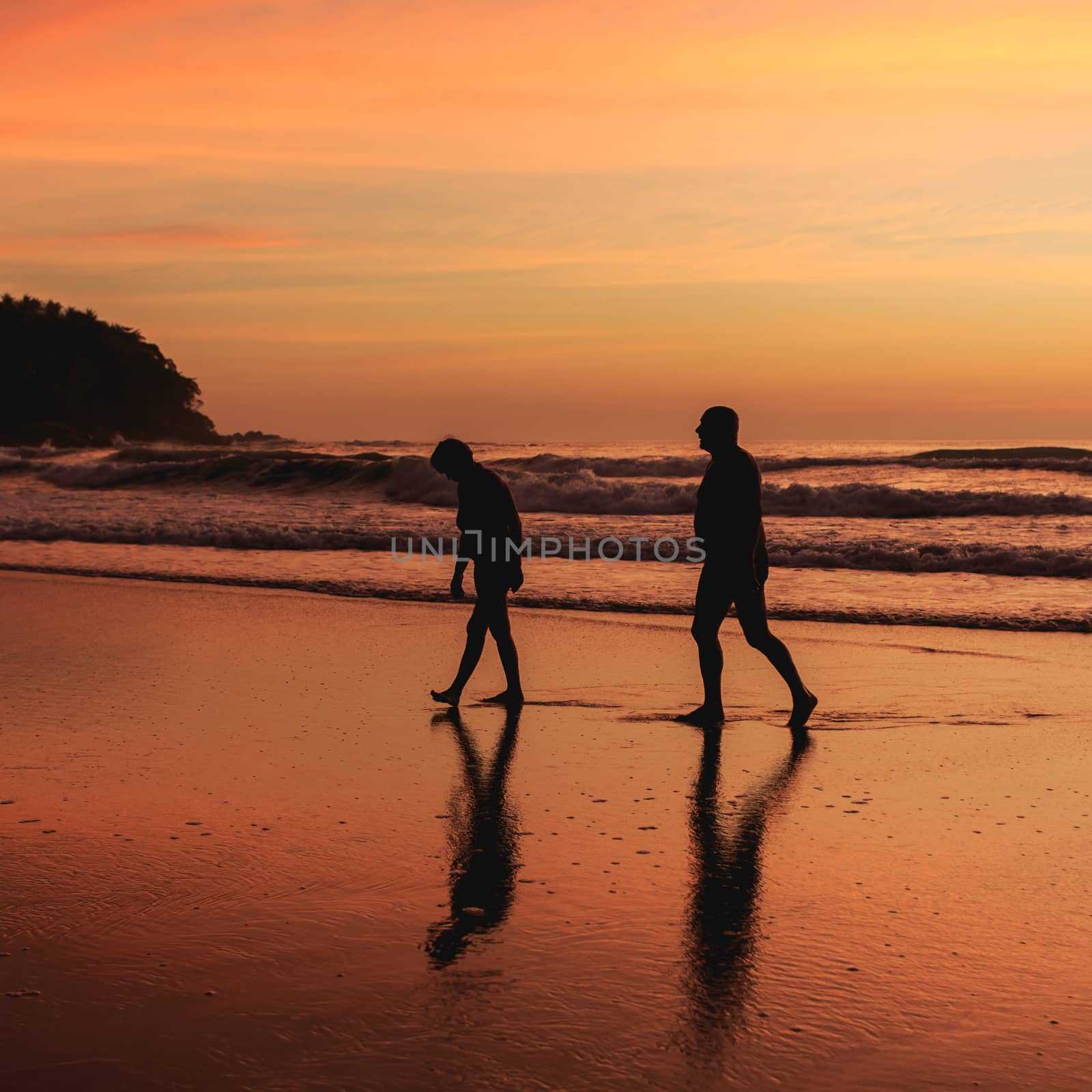 Silhouette of tourist at sunset beach in Phuket Thailand by nanDphanuwat