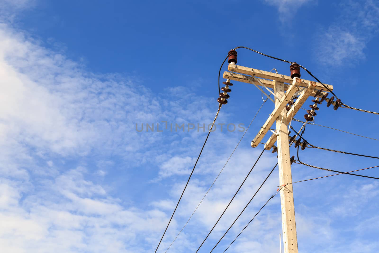 Electric pole power lines and wires with blue sky background by nanDphanuwat