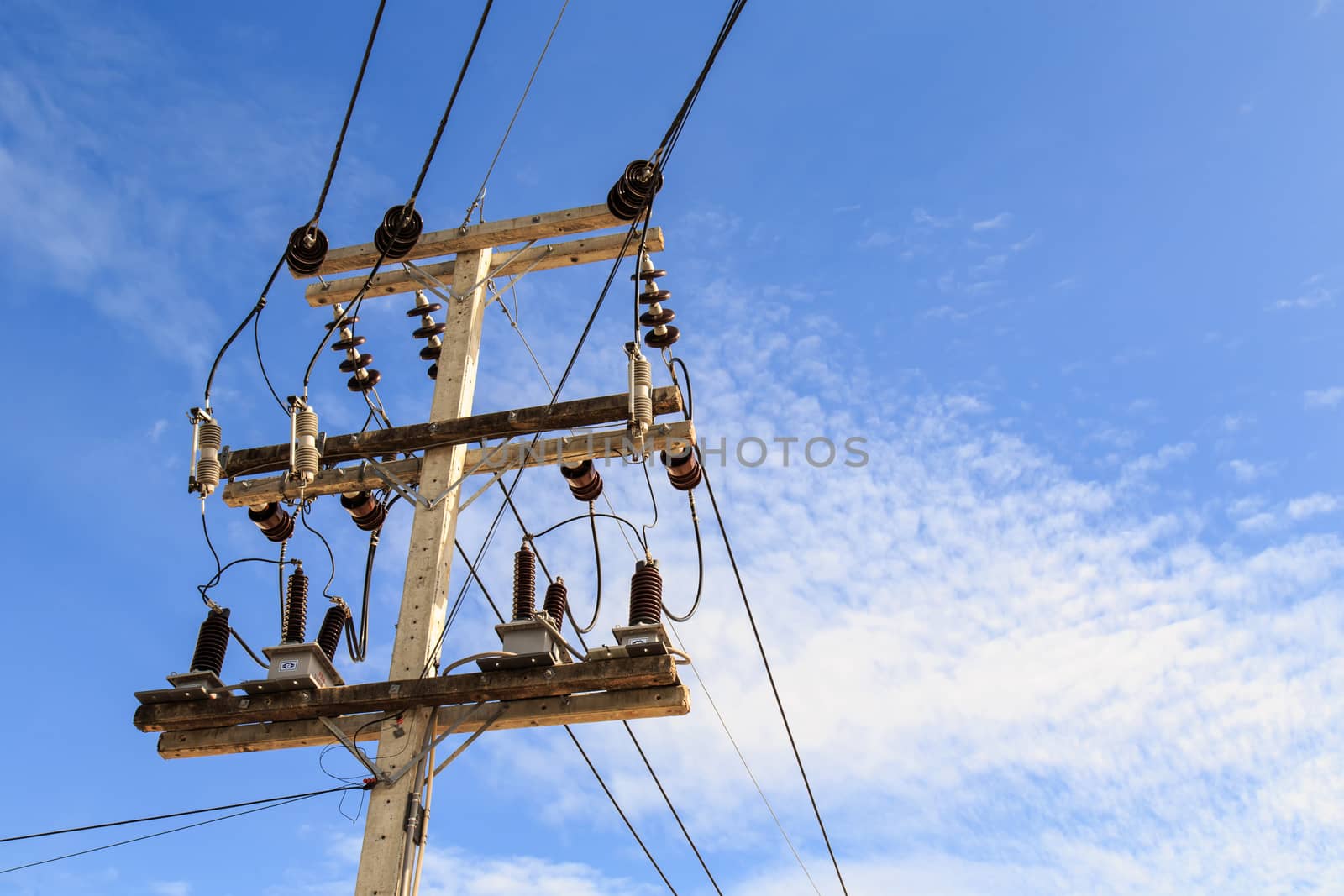 Electric pole power lines and wires with blue sky background by nanDphanuwat