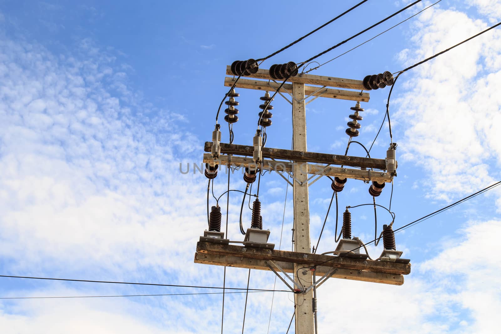 Electric pole power lines and wires with blue sky background by nanDphanuwat