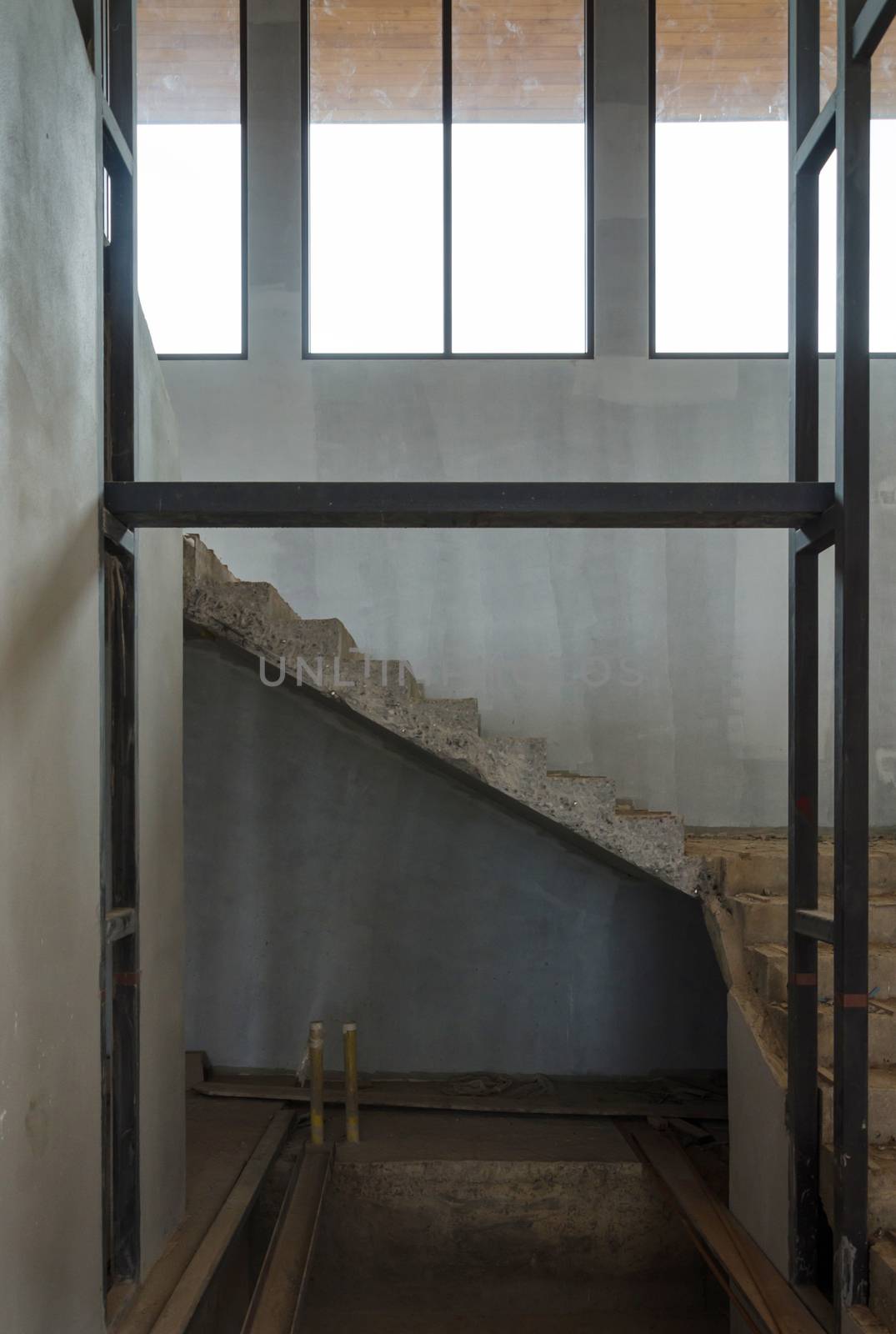 Concrete staircase in the house under construction 