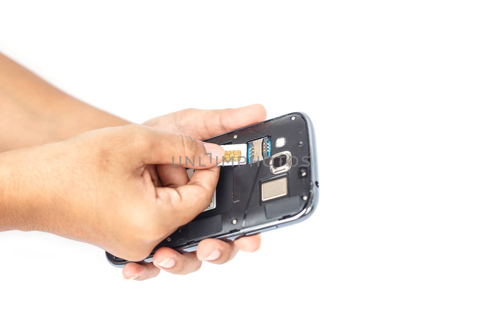 Hand holding sim card and put into smartphone isolated on white background