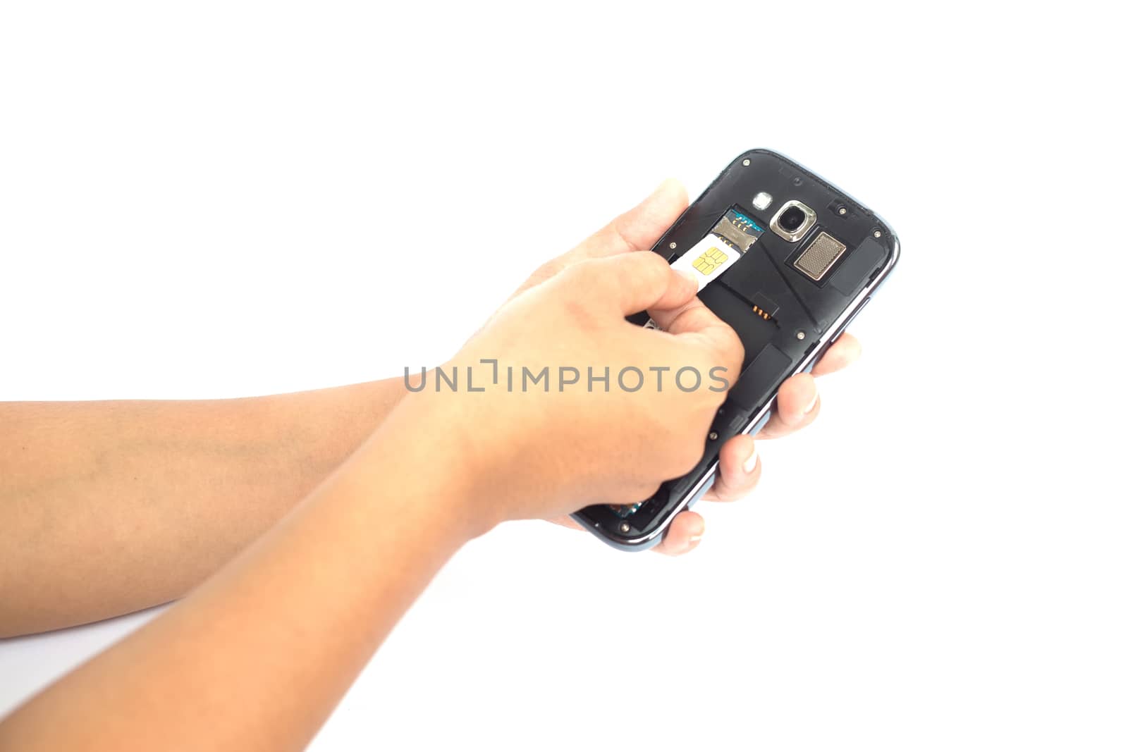 Hand holding sim card and put into smartphone isolated on white  by nanDphanuwat
