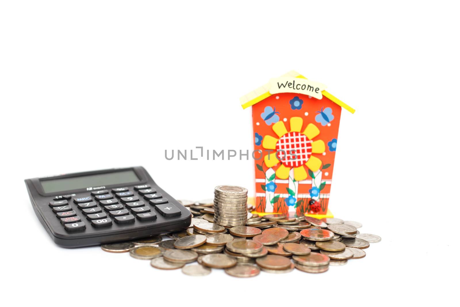 piggy bank with stack of coin and calculator isolated on white background