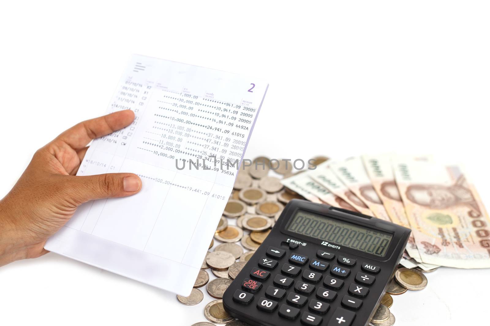 Hand holding book bank and stack of money in consept checking money in the account isolated on white background