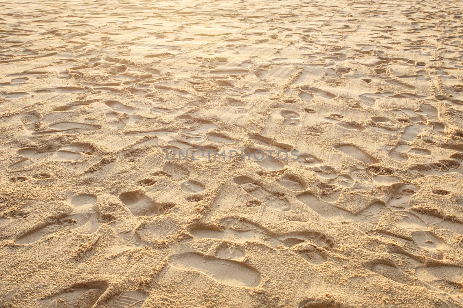 Texture of sand and footprints in the sand