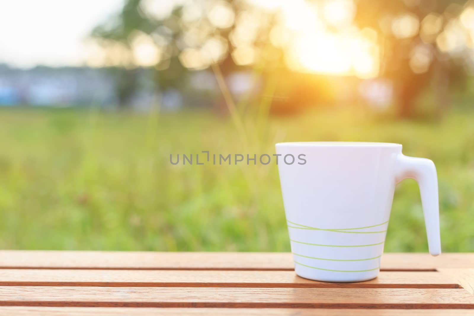 Coffee cup on the table in sunset time