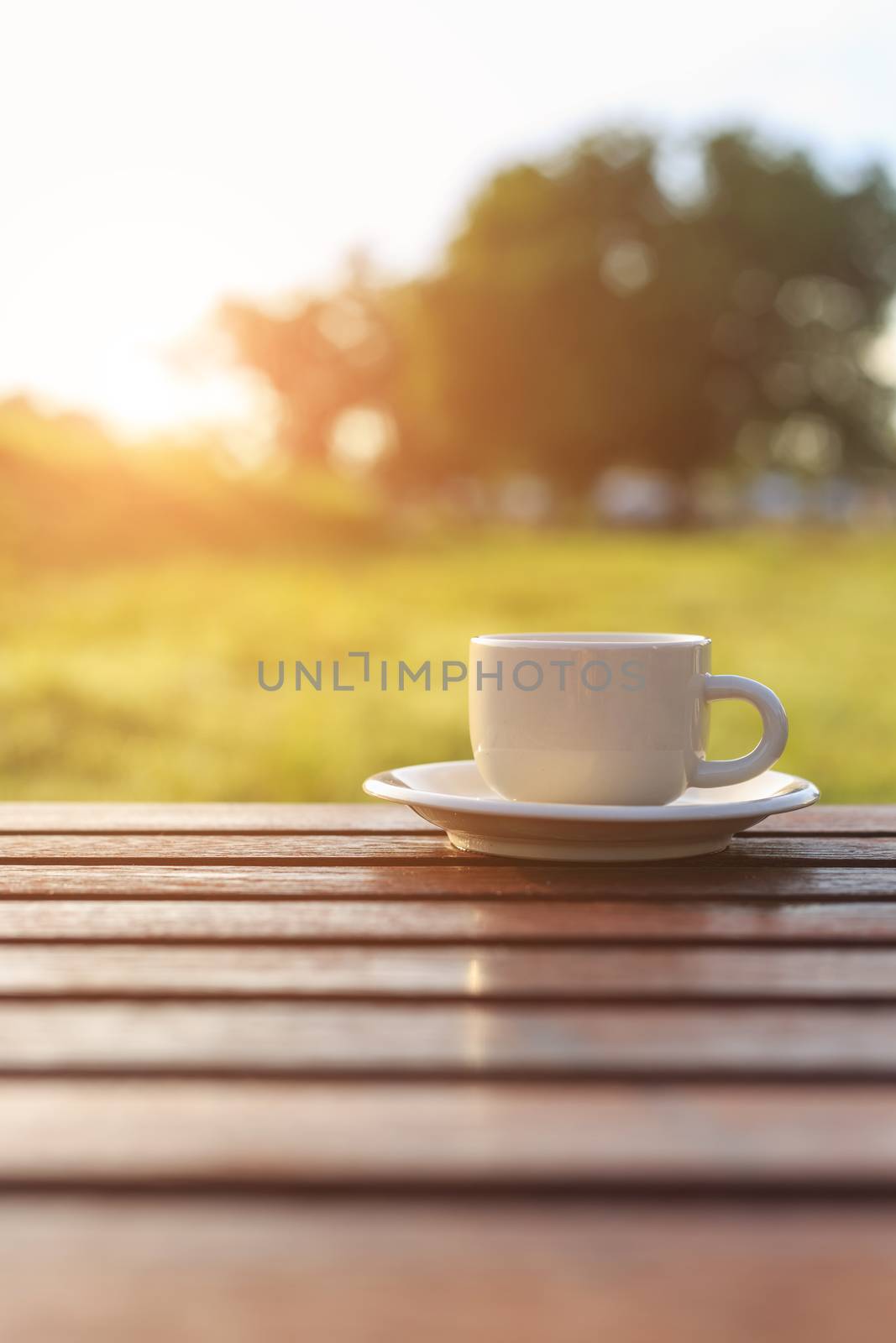 Coffee cup on the table in sunset time