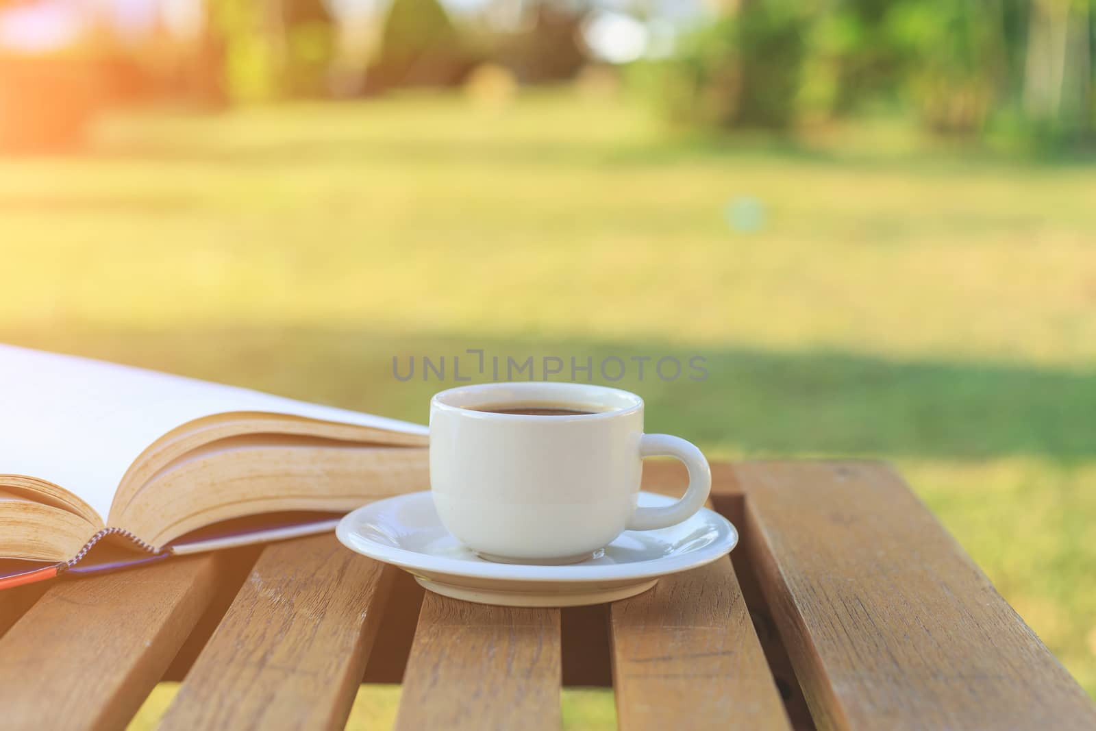 Coffee cup and book on the table in the morning
