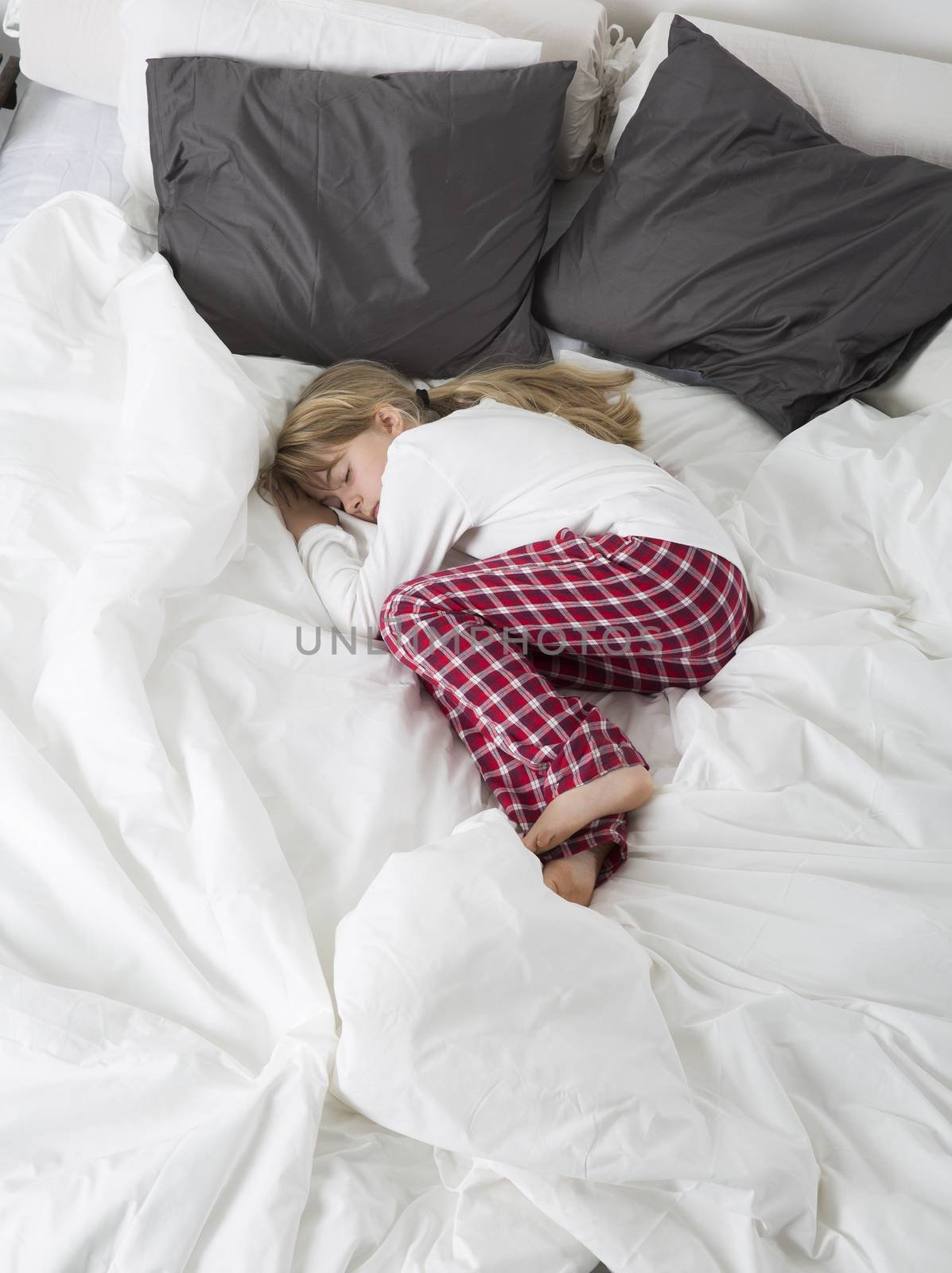 Little Girl sleeping in a big bed