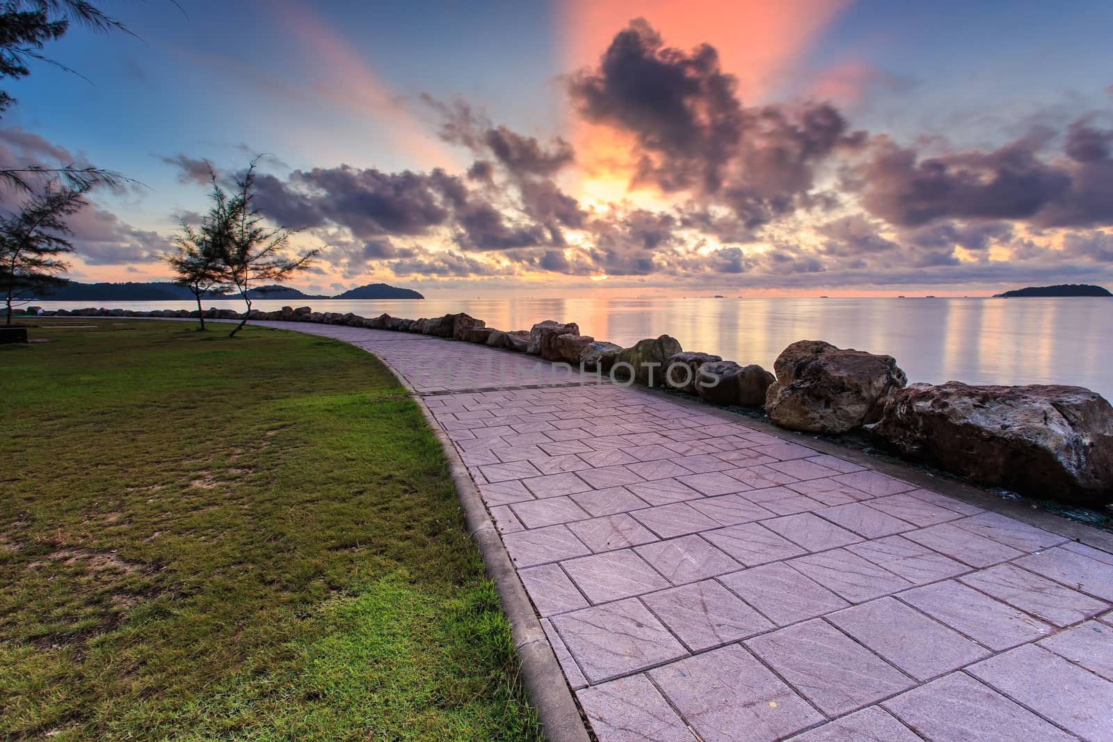 Stone path beside the sea and sunrise