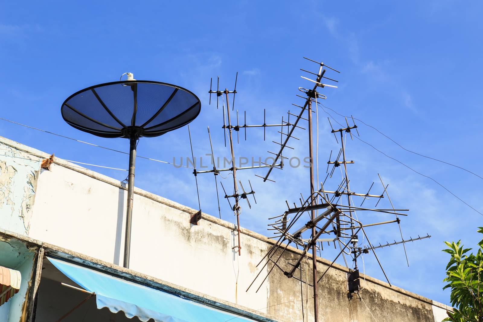 Satellite dish on roof and blue sky