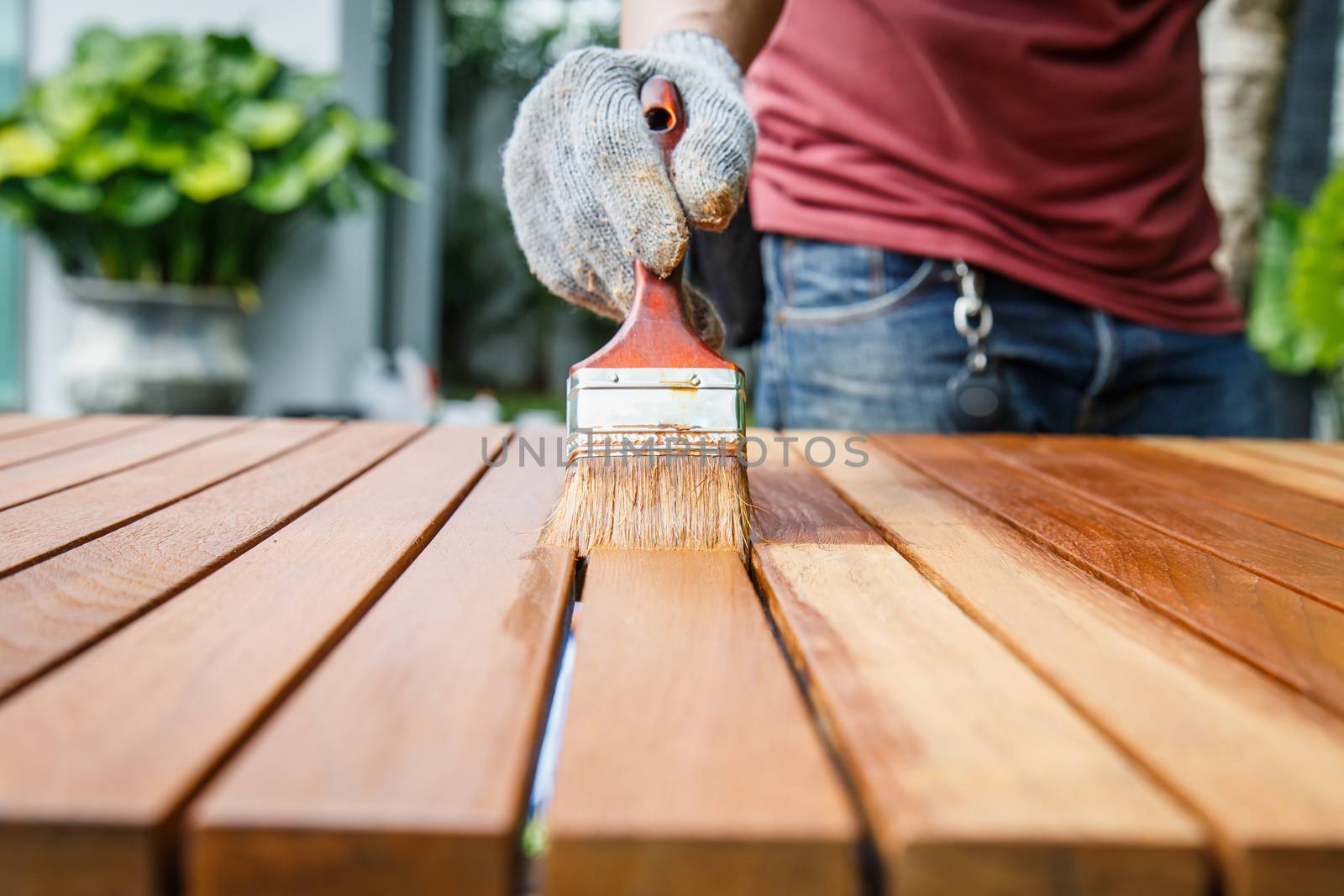 Brush in hand and painting on the wooden table