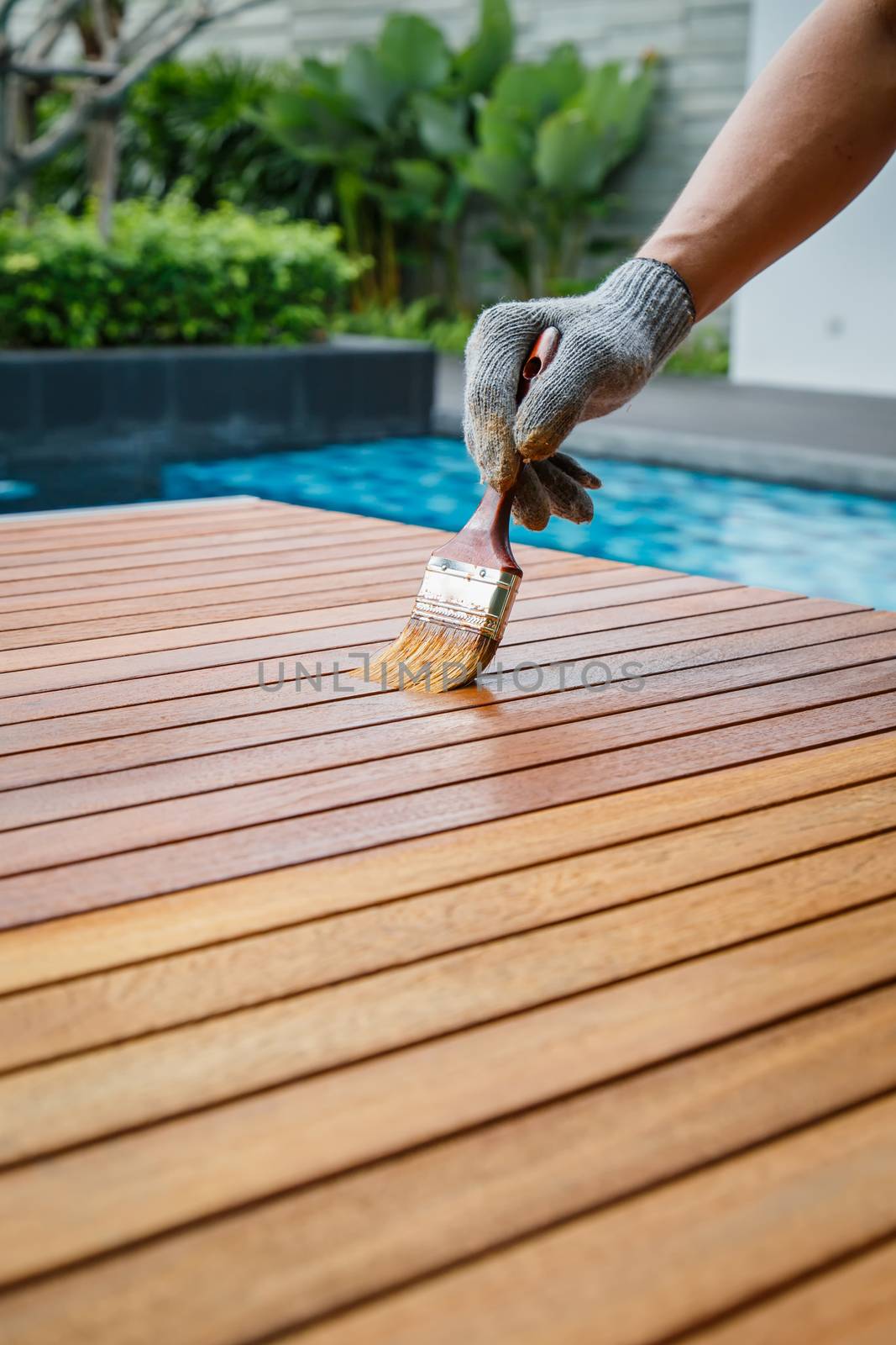 Brush in hand and painting on the wooden table