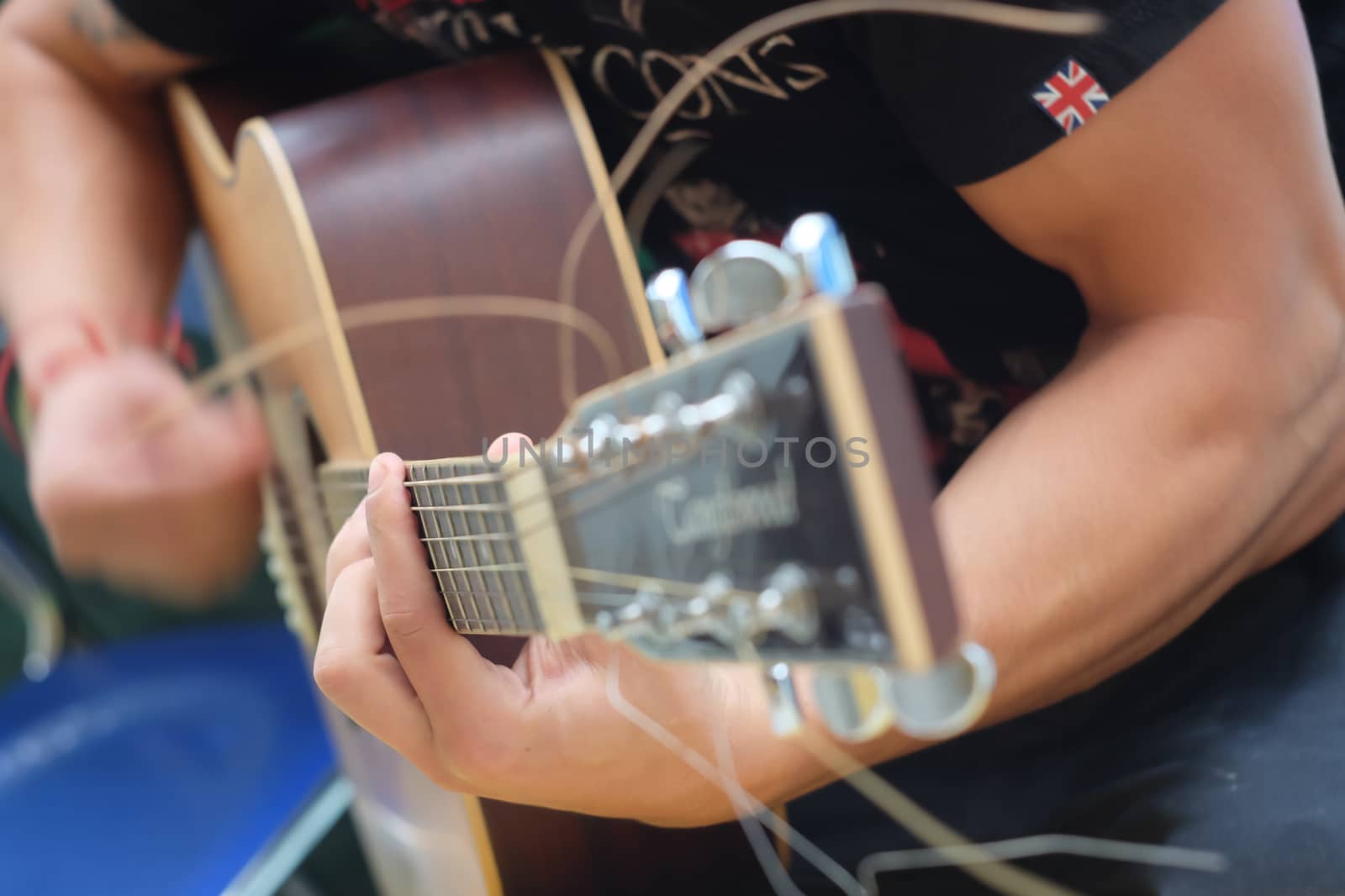 Close up on hand of guitar player tuning some arrangements