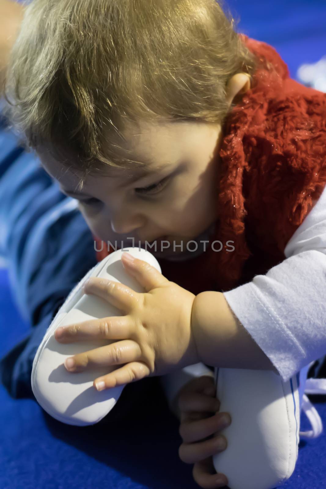 Italian baby girl playing with her foot by Mag6619