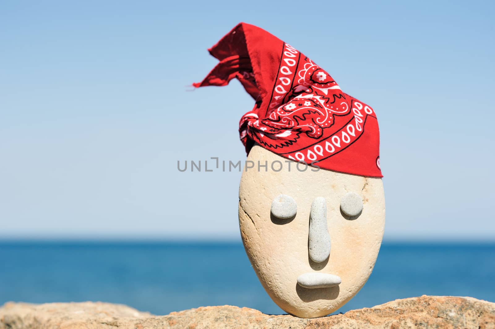 Symbol of stone head with a patterned red bandana