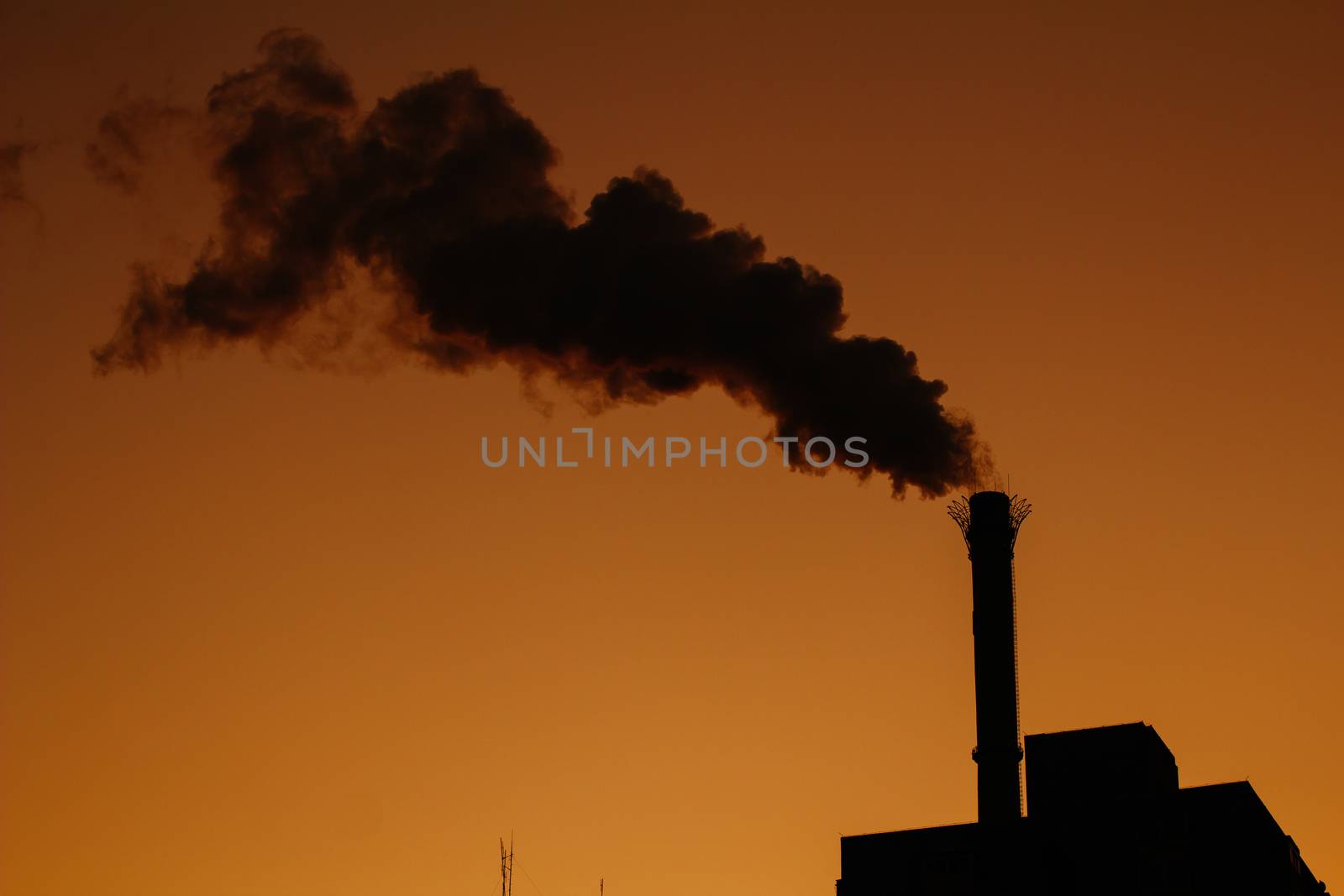 Chimney is smoking, under the twilight