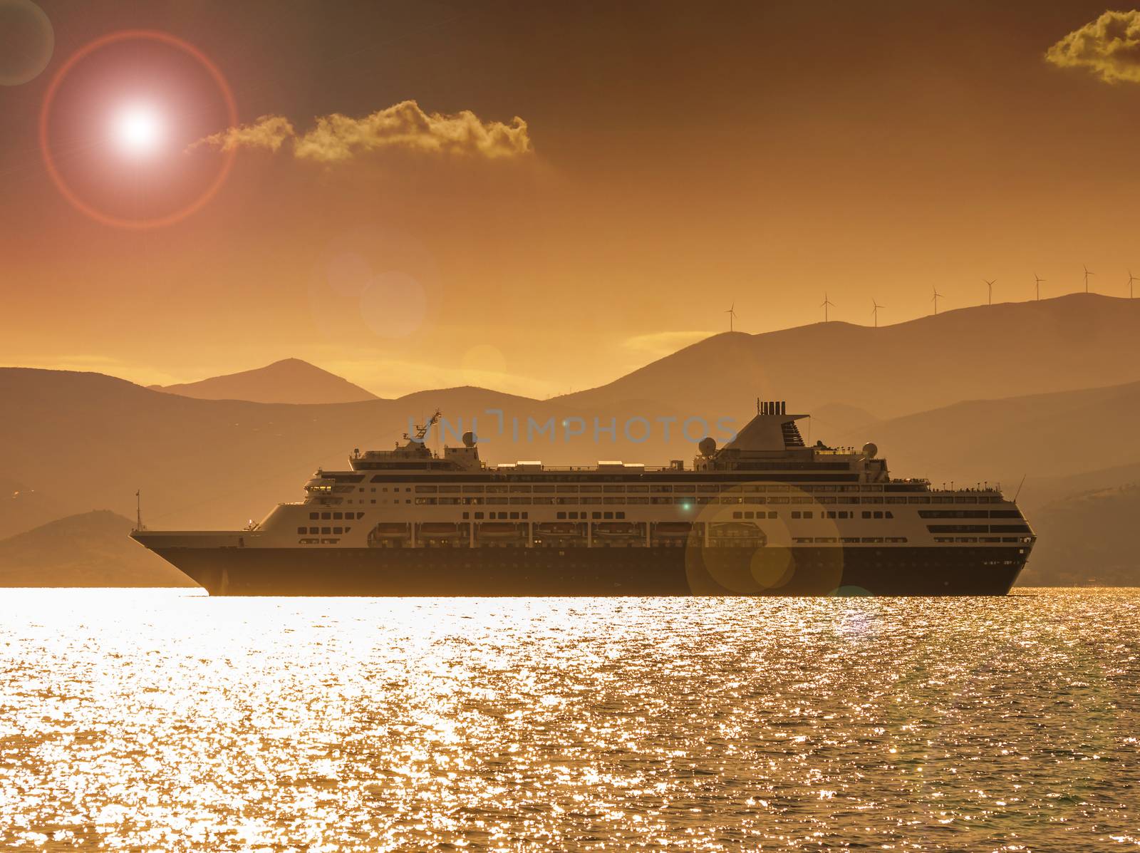 Small cruise ship at sunset off the coast of Greece