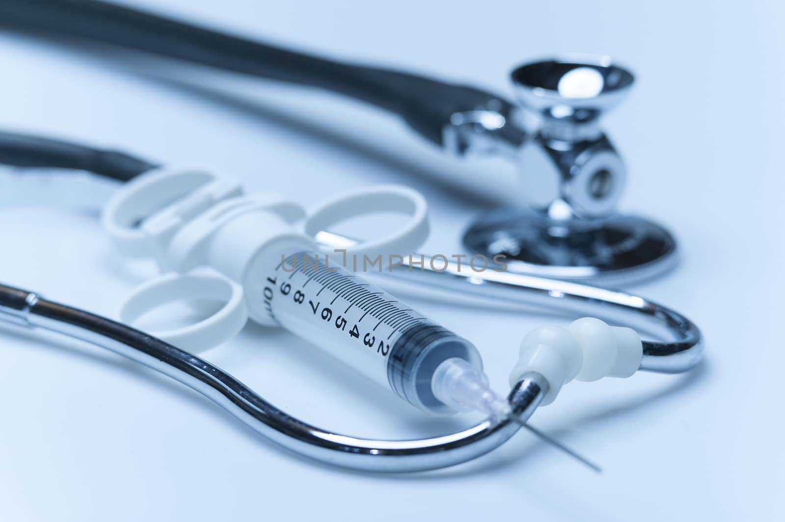 Doctor's medical tools consisting of syringe and stethoscope