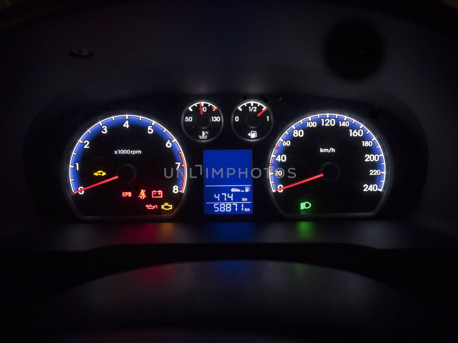 Car dashboard instrument panel with dials and guages all lit up