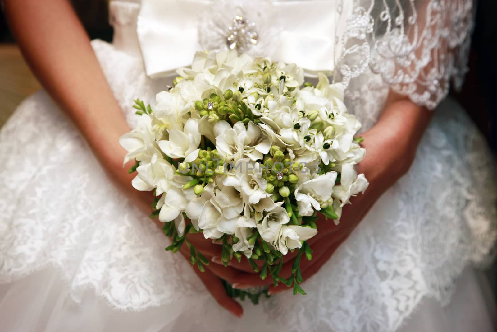 The bride holds a wedding bouquet