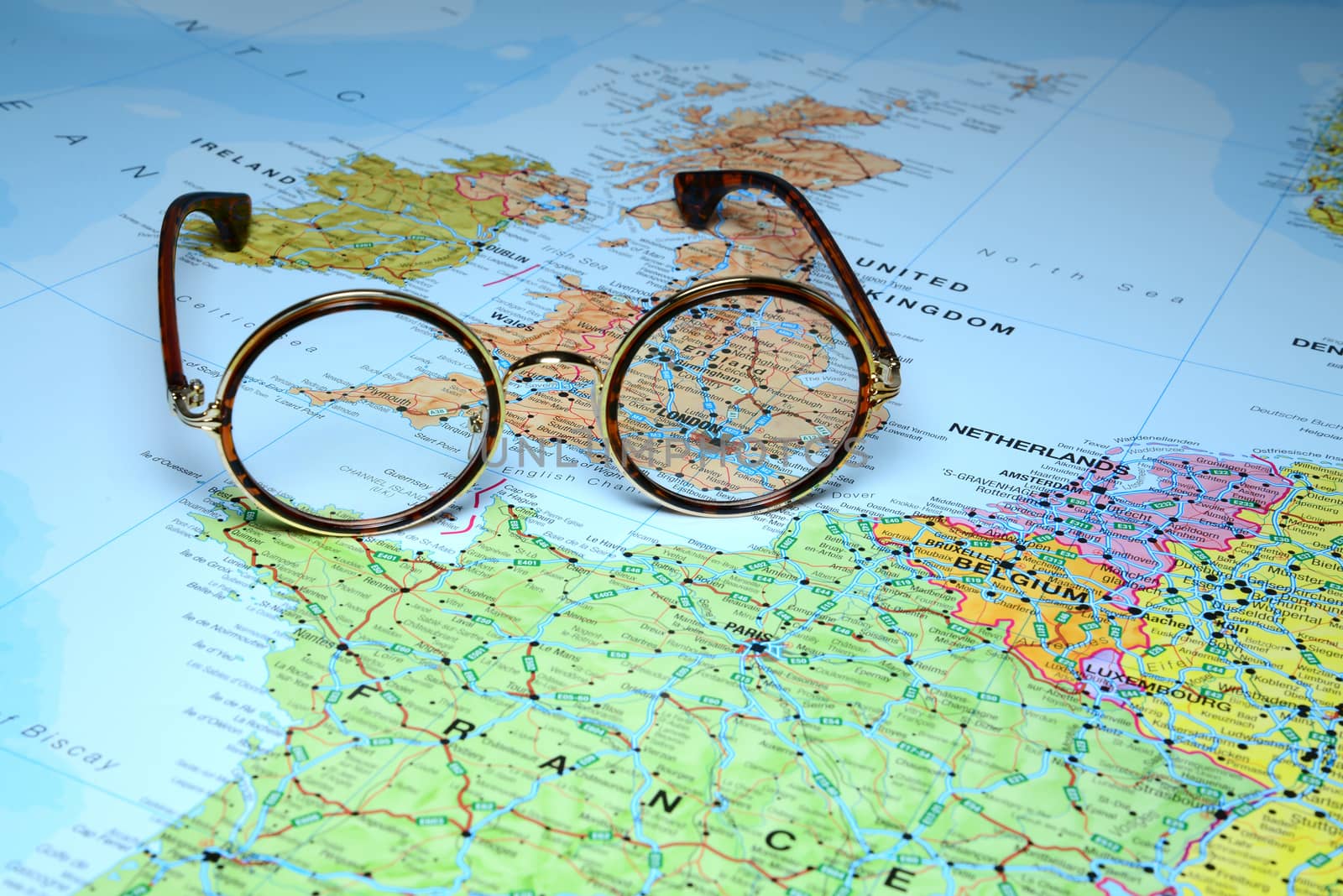 Photo of glasses on a map of europe. Focus on London, Great Britain. May be used as illustration for traveling theme.