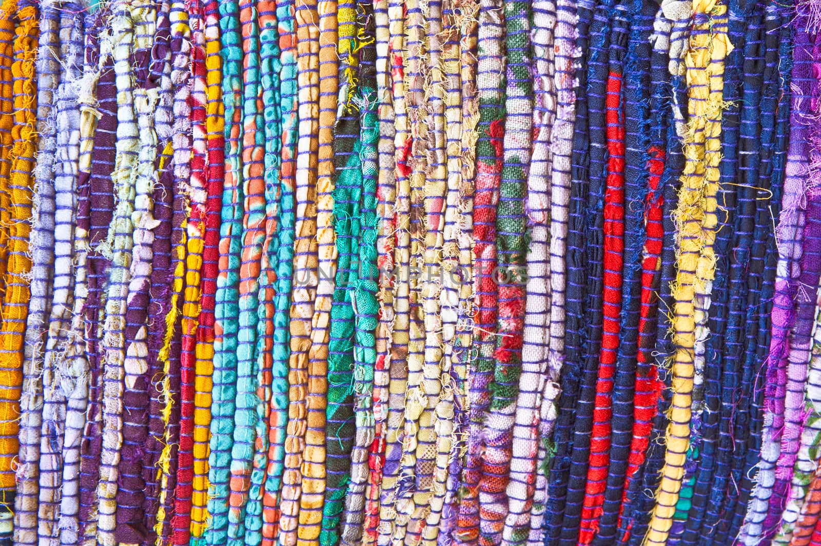 Part of a colorful rug made from recycled textiles