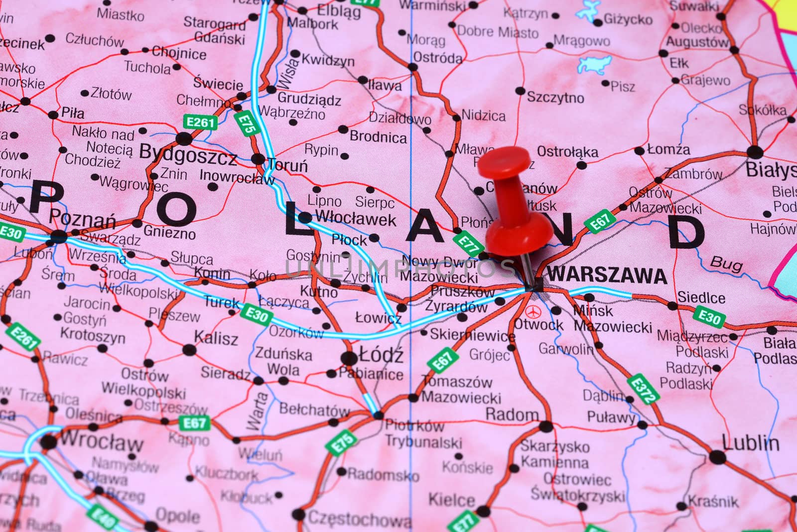 Photo of pinned Warsaw on a map of europe. May be used as illustration for traveling theme.