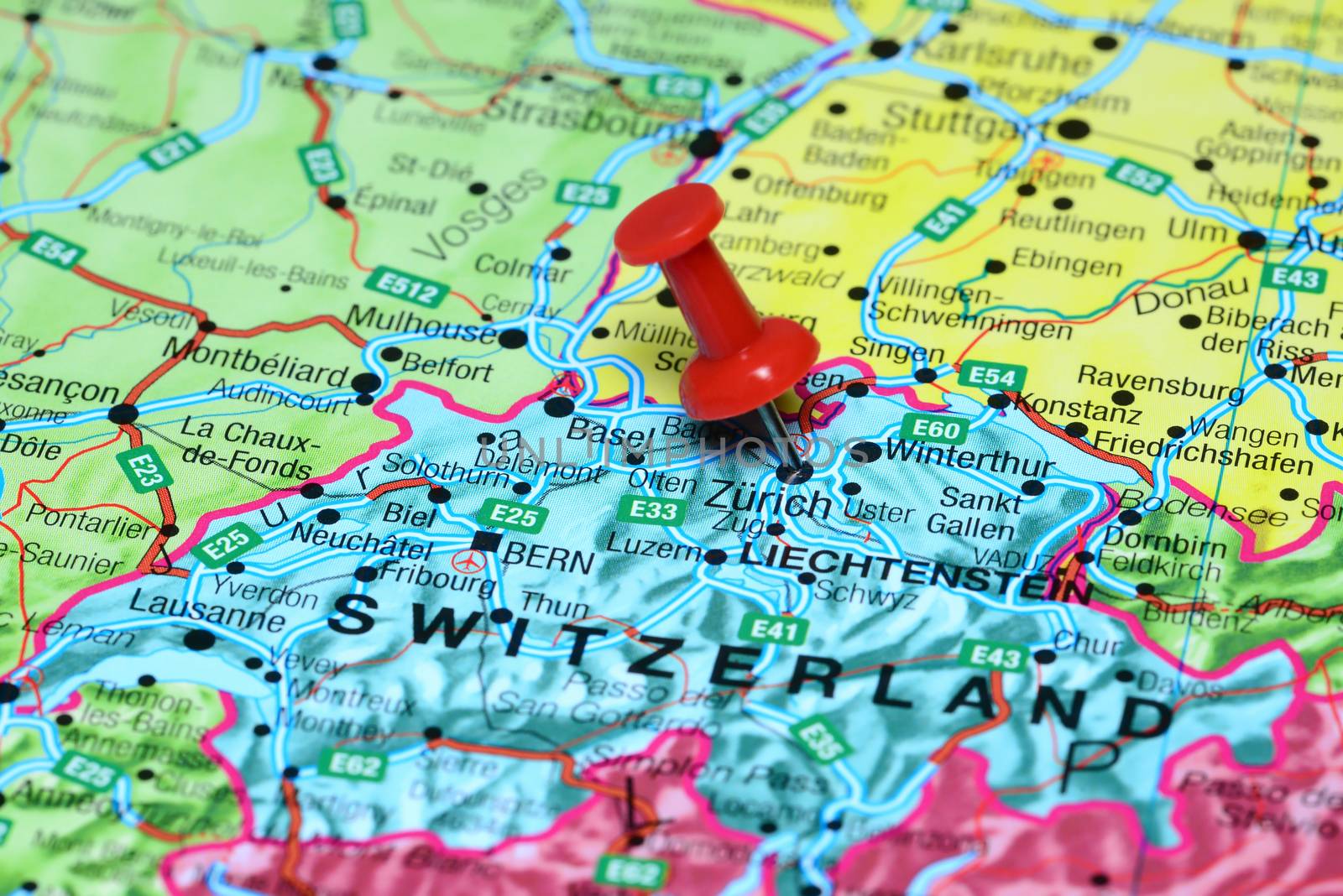 Photo of pinned Zurich on a map of europe. May be used as illustration for traveling theme.