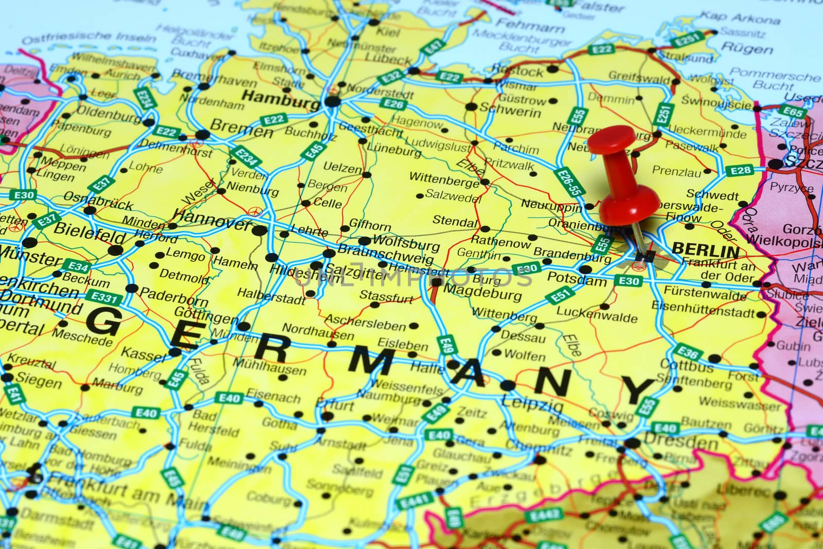 Photo of pinned Berlin on a map of europe. May be used as illustration for traveling theme.