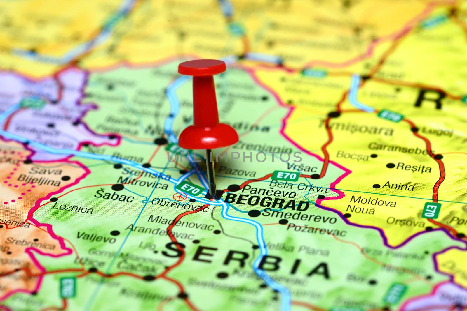 Photo of pinned Belgrade on a map of europe. May be used as illustration for traveling theme.