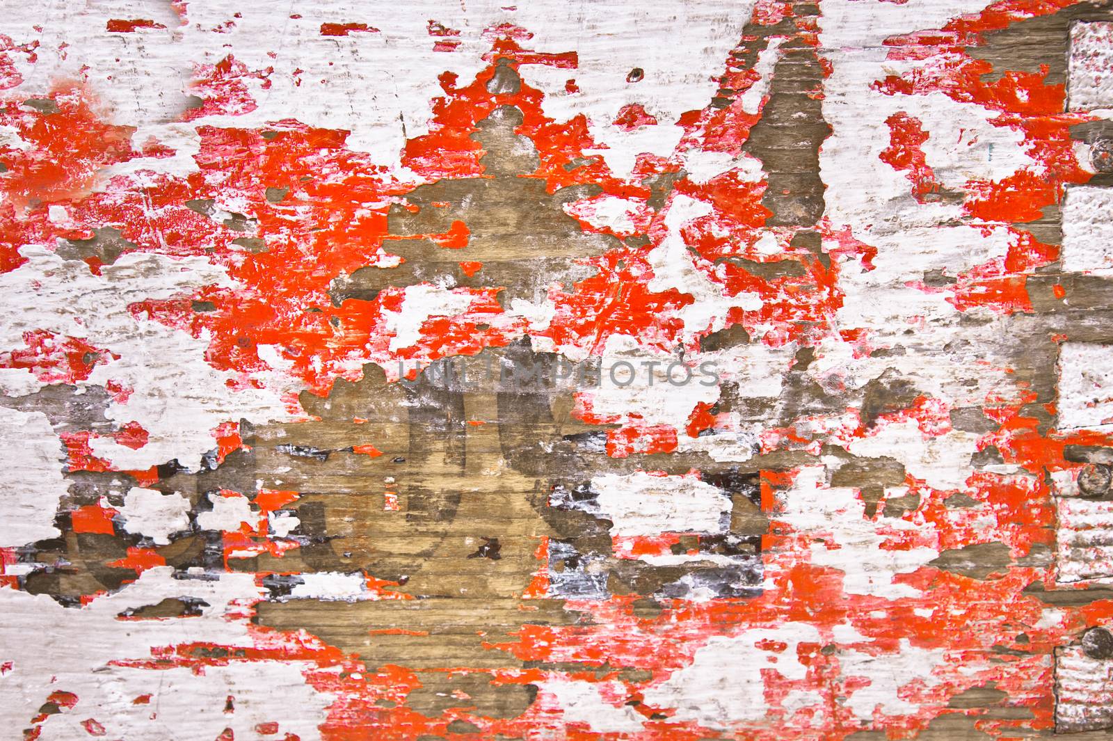 Red and white peeling paint on an old cargo box