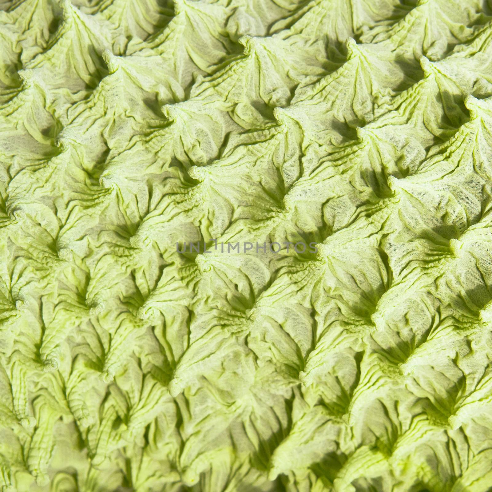 Part of a textured green fabric as a background