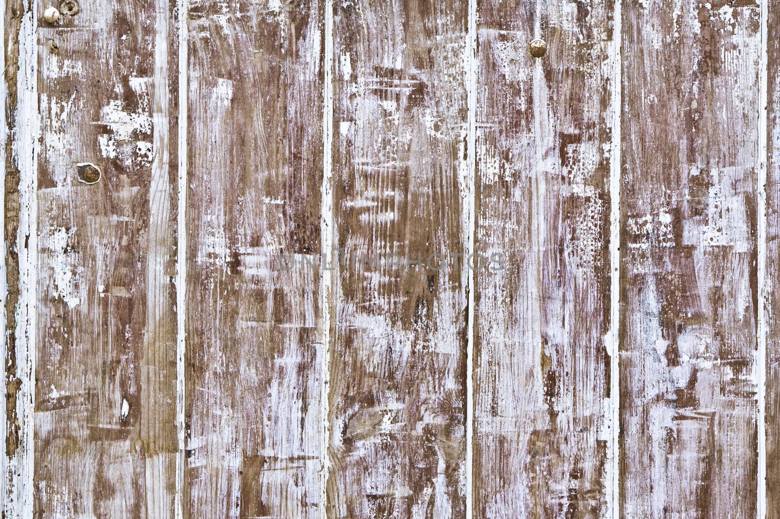 Weathered wood with peeling white paint