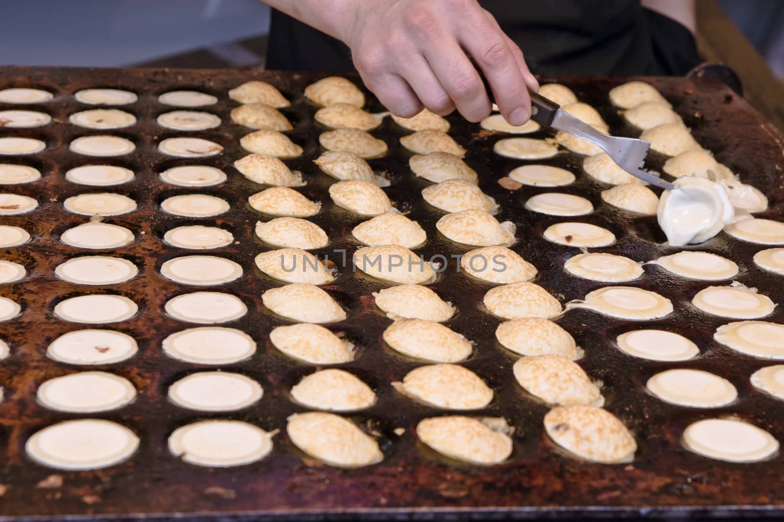 Dutch pancakes (poffertjes) being made at a market stall