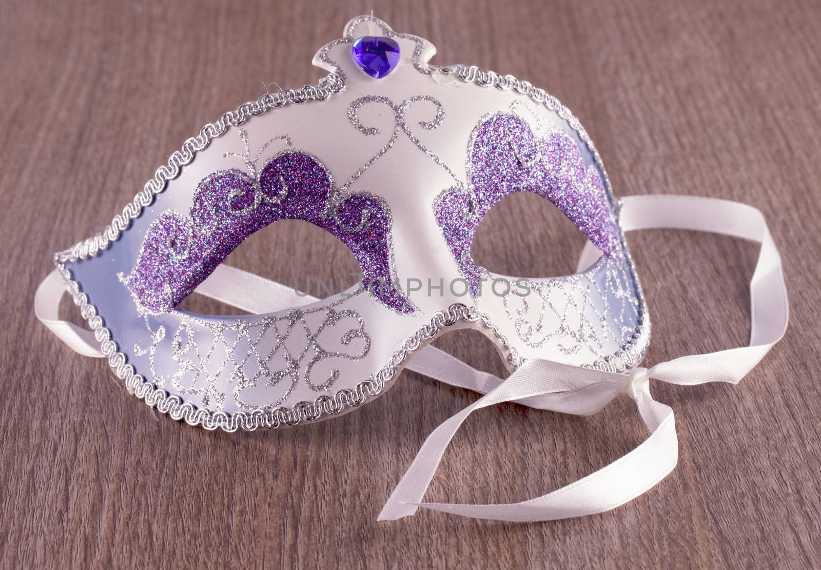 Venetian mask ion close up over wooden background