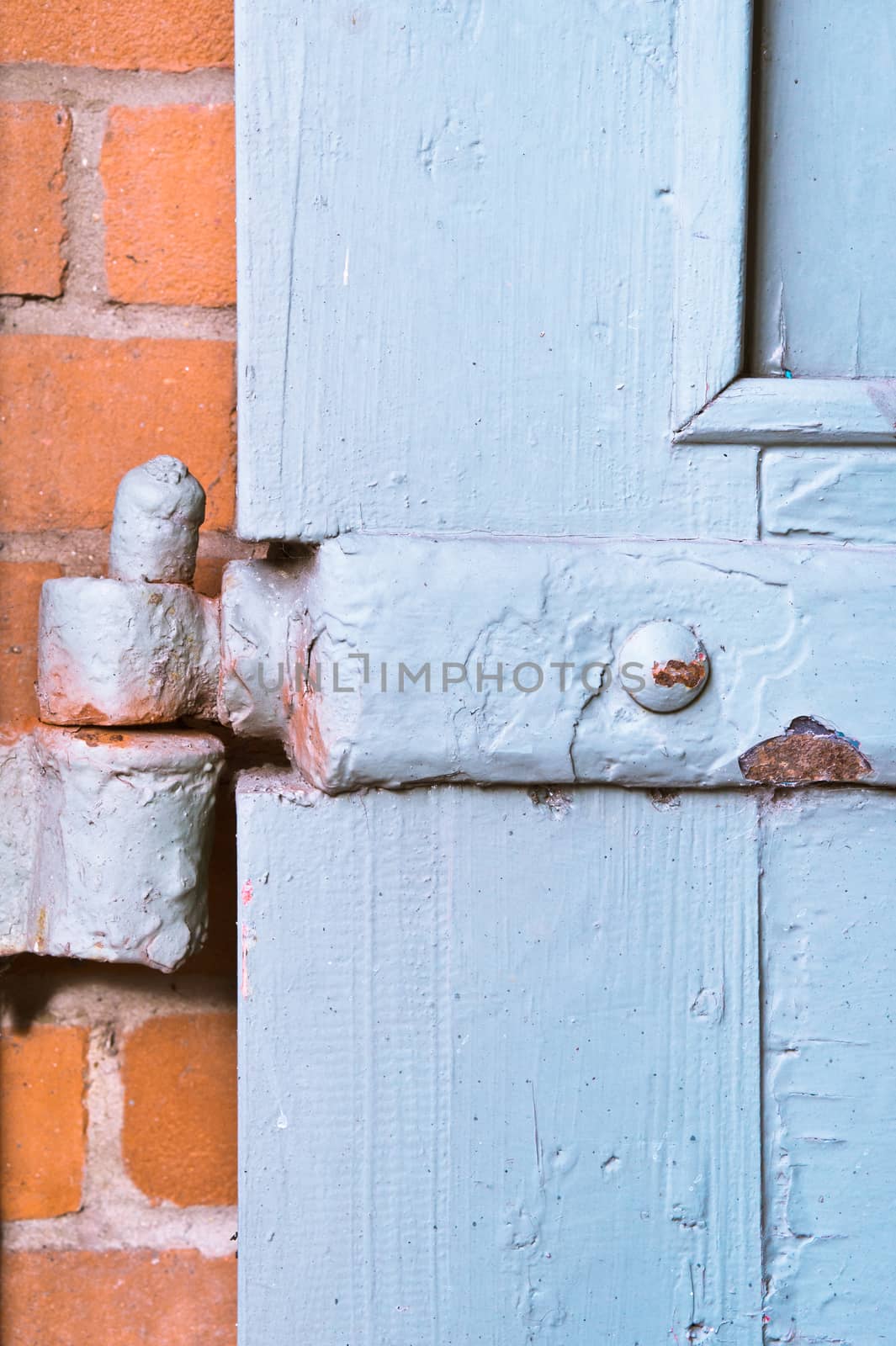 Old hinge on a wooden door