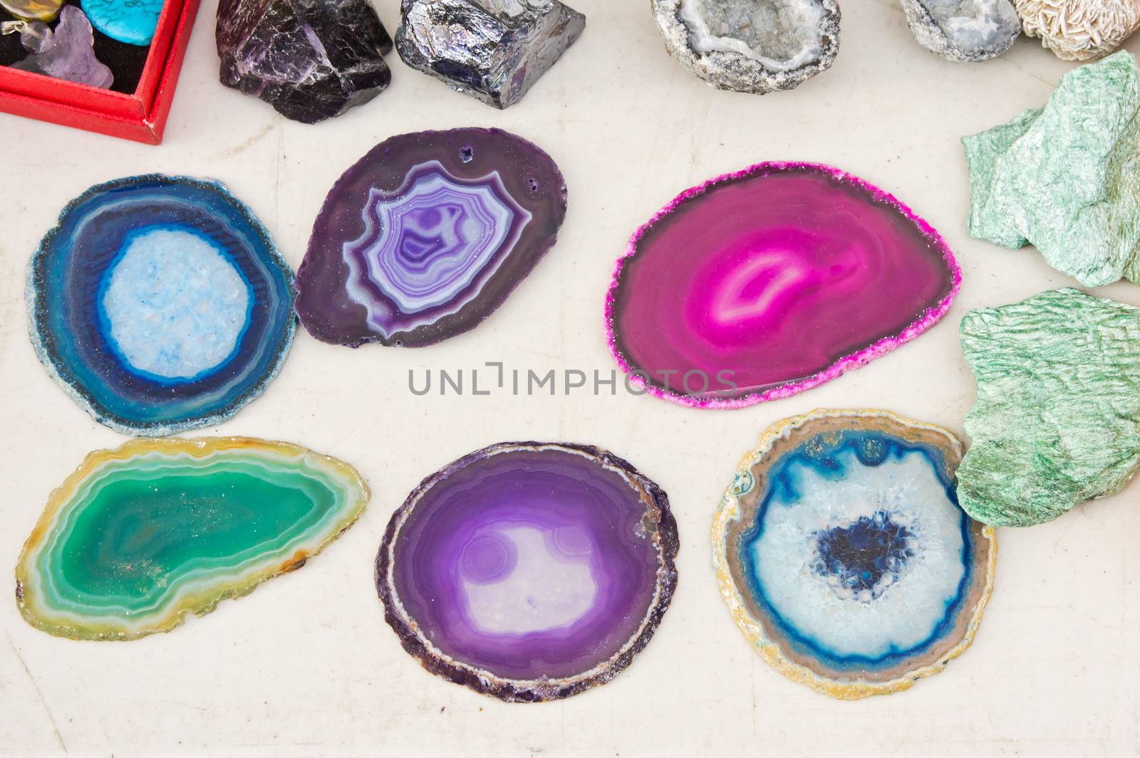 Colorful stones on display on a white surface