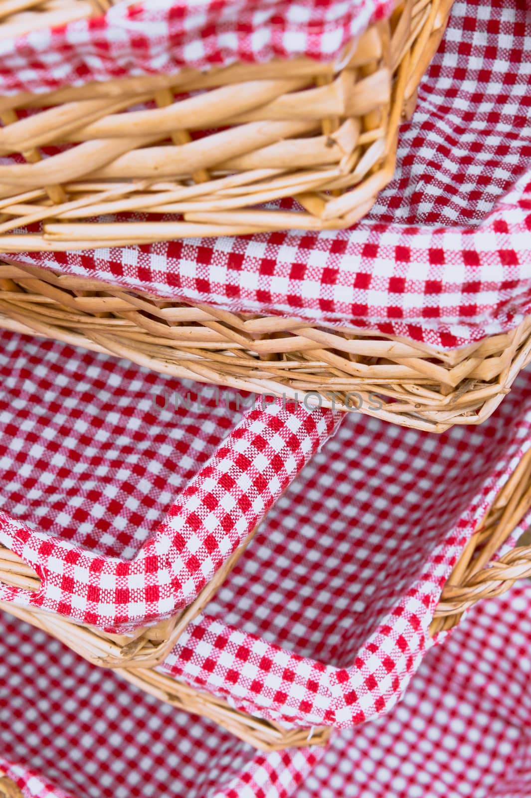 Pile of straw baskets lined by gingham cloths